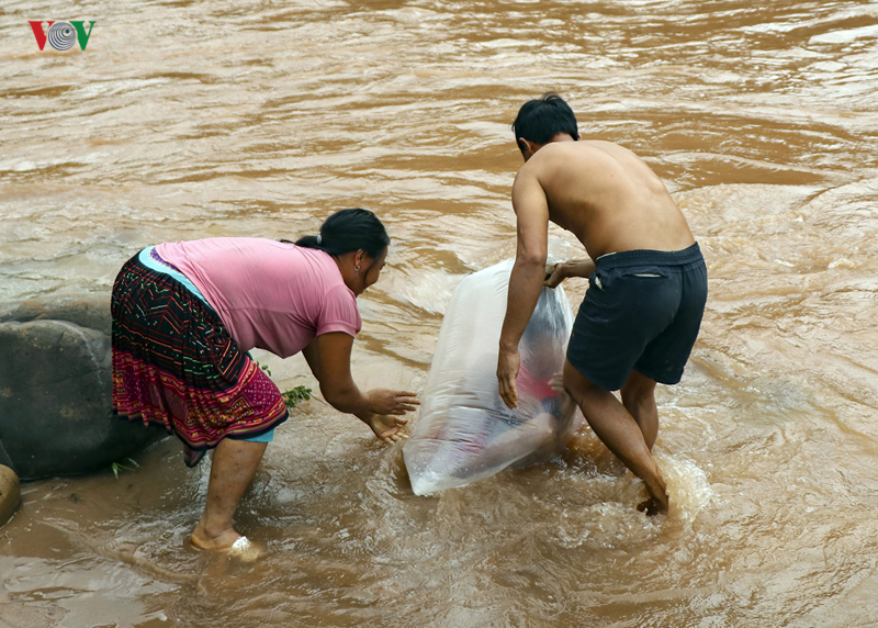 Estudantes são transportados em sacos em rio para não se molharem 03
